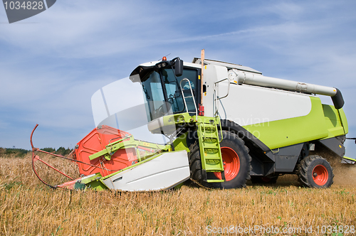 Image of working harvesting combine in field