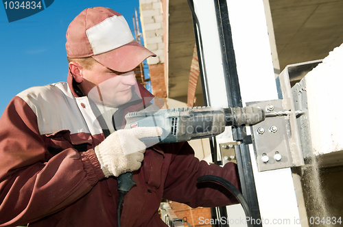 Image of builder with drill