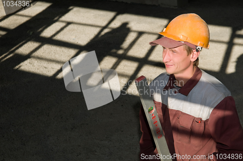 Image of worker builder with level