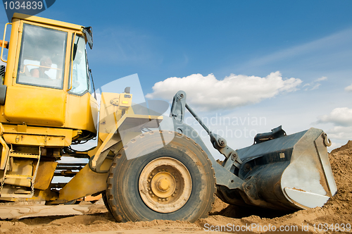 Image of wheel loader over blue sky