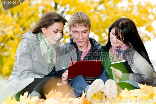 Image of Group of smiling young students outdoors