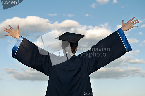 Image of happy graduate with risen arms