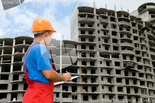 Image of builder and building under construction