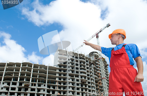 Image of builder and building under construction