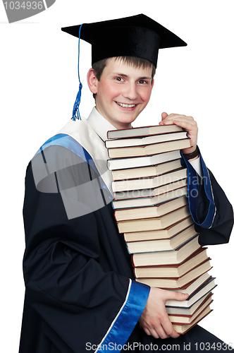 Image of graduate in gown with books