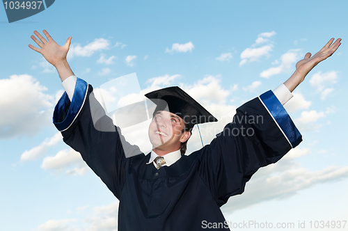 Image of happy graduate with risen arms