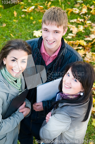 Image of Group of smiling young students outdoors