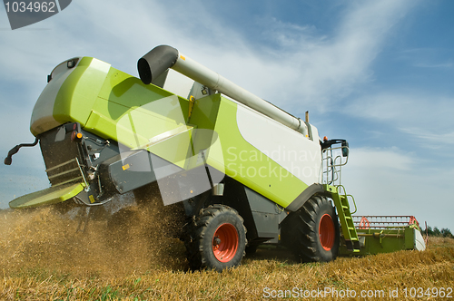 Image of harvesting combine in field