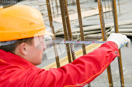 Image of builder with measure tape