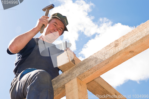 Image of roofing works with hammer