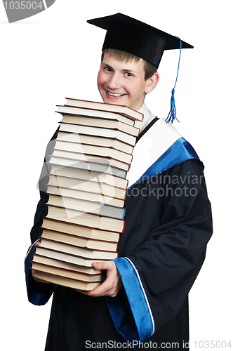 Image of graduate in gown with books