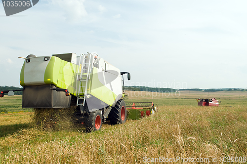 Image of Two working harvesting combines