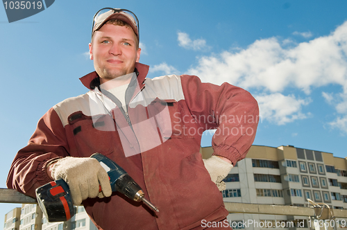 Image of happy worker with screwdriver