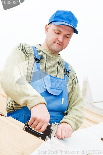 Image of roofing works with staple gun