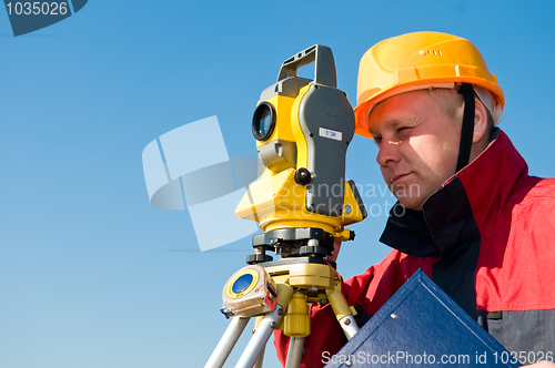 Image of Surveyor looking at the thedolite