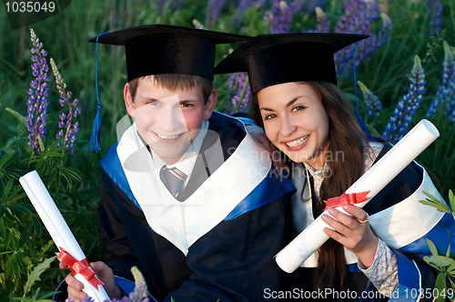 Image of Two smiley Graduate outdoors