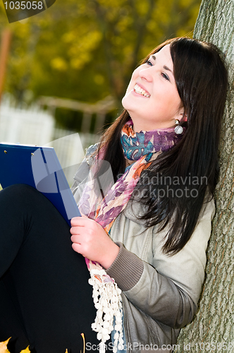 Image of Portrait of cheerful student outdoors