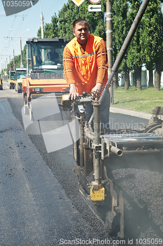 Image of Young paver worker at asphalting works