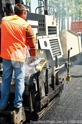 Image of Young paver worker at asphalting works