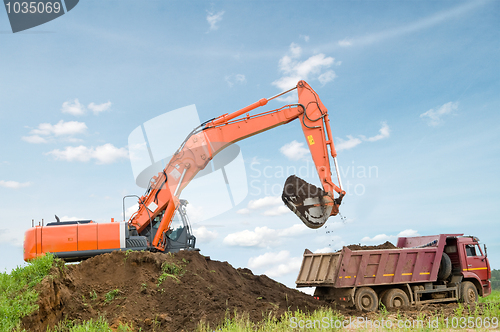 Image of excavator and dumper truck