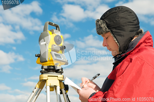 Image of surveyor works with theodolite