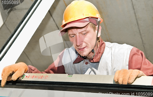 Image of Builder laborer using level tool