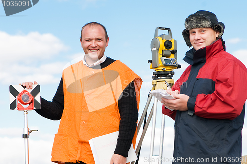 Image of surveyor workers with theodolite equipment