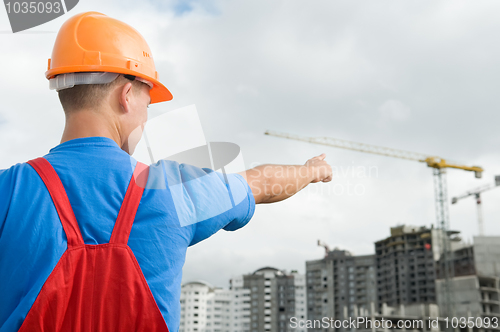 Image of builder and building under construction