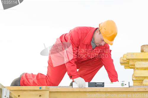 Image of builder with digital level
