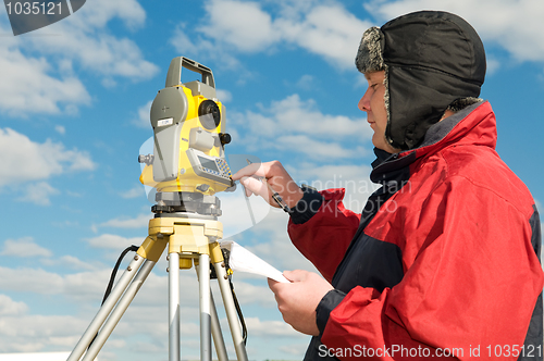 Image of surveyor works with theodolite