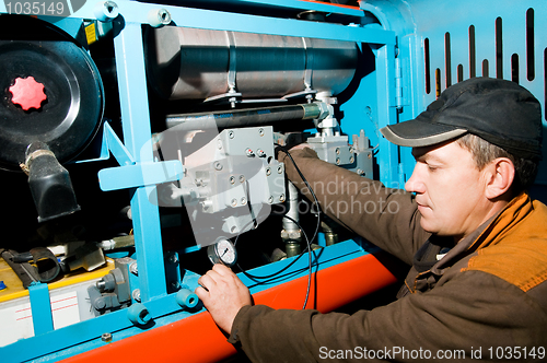 Image of repairman using manometer