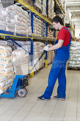 Image of warehouse worker with forklift stacker