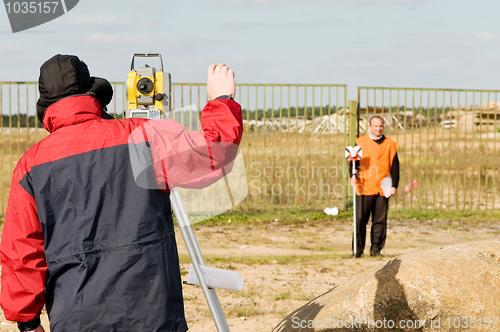 Image of surveyor works with theodolite