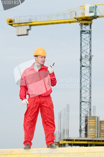 Image of builder operating the tower crane