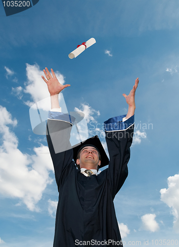 Image of graduate in cloak throwing diploma