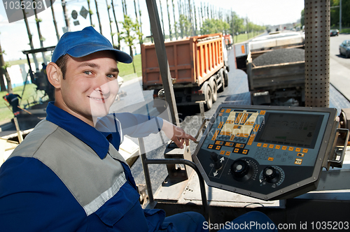 Image of Young paver worker at asphalting works