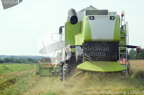 Image of working harvesting combine in field