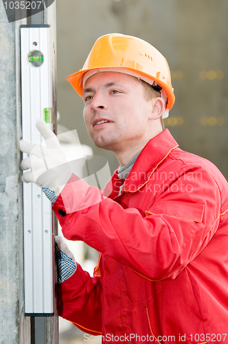 Image of builder with digital level