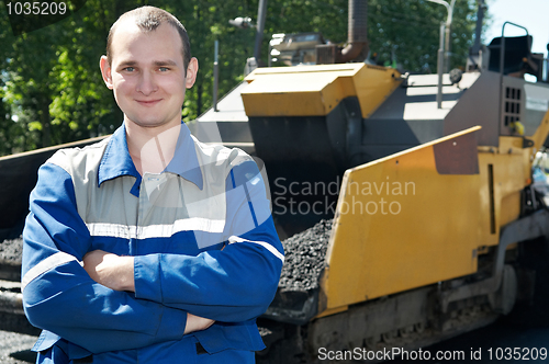 Image of Young paver worker at asphalting works