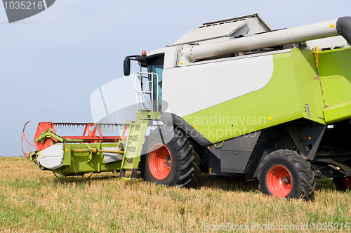 Image of working harvesting combine in field