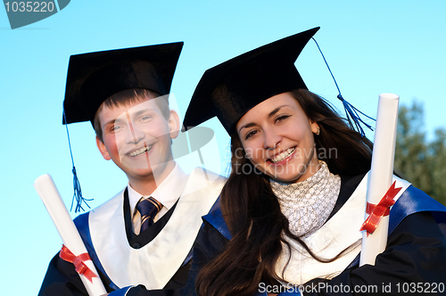 Image of Two smiley Graduate outdoors