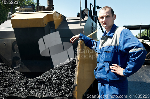 Image of Young paver worker at asphalting works