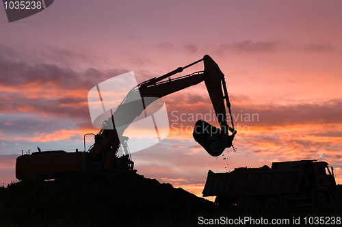 Image of excavator and dumper truck