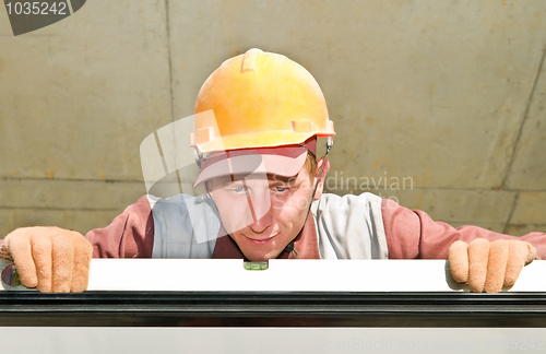 Image of Builder worker using level tool
