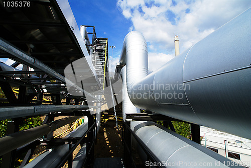 Image of Industrial zone, Steel pipelines and valves against blue sky