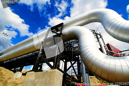 Image of Industrial zone, Steel pipelines and valves against blue sky