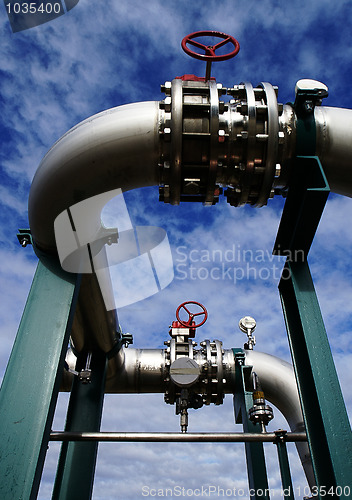 Image of Industrial zone, Steel pipelines and valves against blue sky