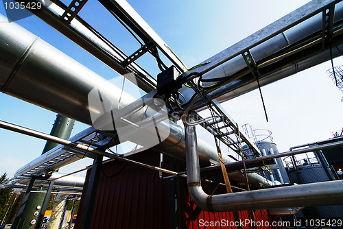 Image of Industrial zone, Steel pipelines and valves against blue sky