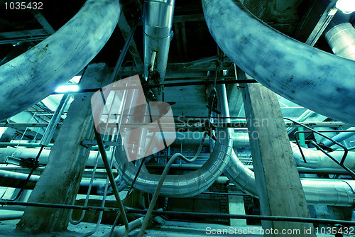 Image of different size and shaped pipes and valves at a power plant 