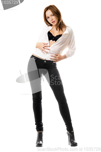Image of Young woman in black tight jeans